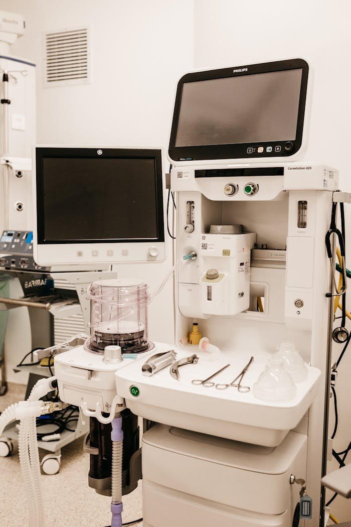 Home High-tech medical equipment setup in a hospital room, featuring monitors and surgical tools.